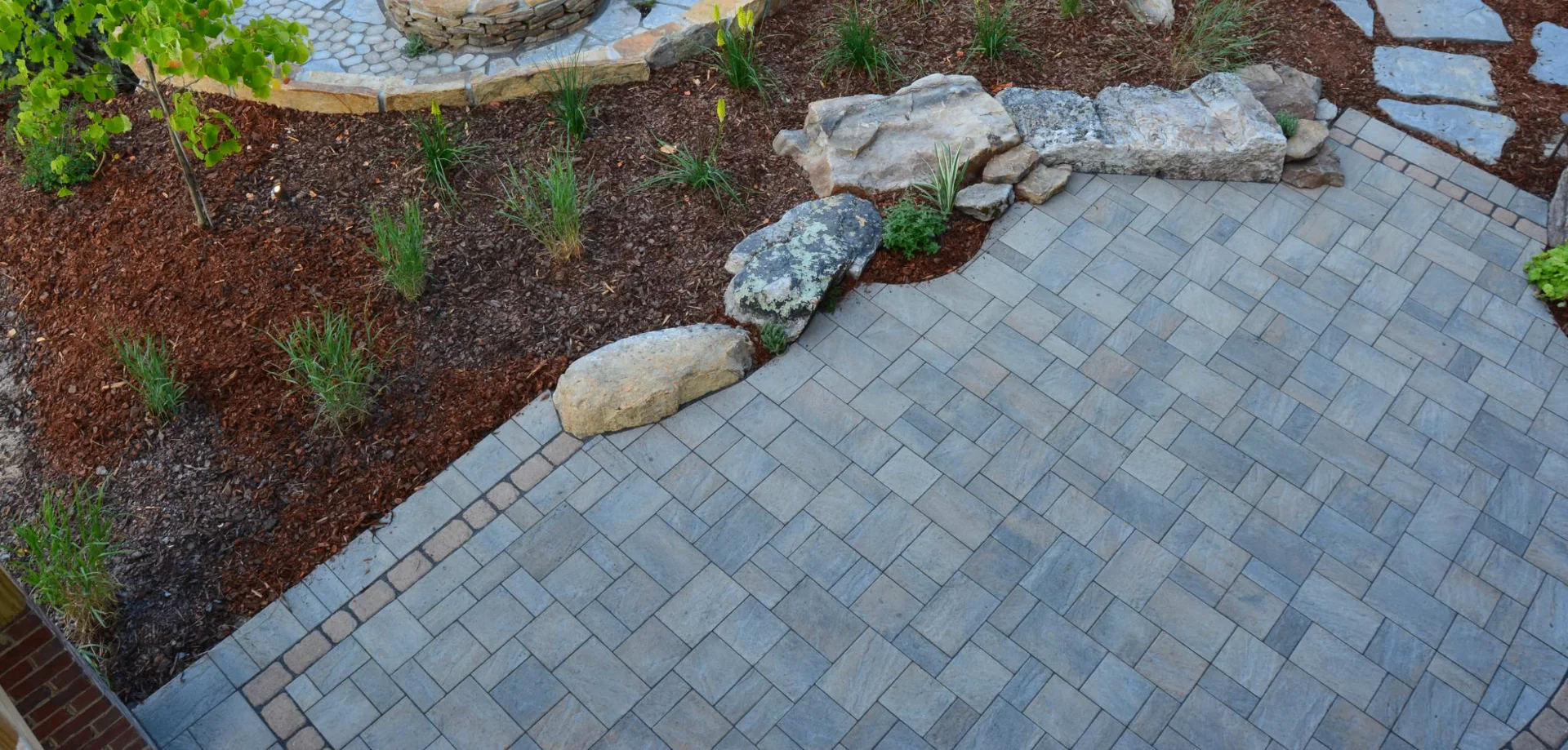 Compact Lot Outdoor Living — Paver dining pad, corner fire seating, vertical planting, string lighting in Grant Hill, San Diego